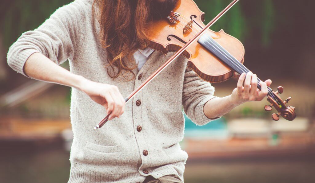 A young woman playing a violin.