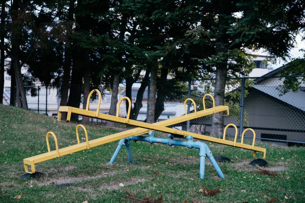 Bright yellow and blue seesaws.